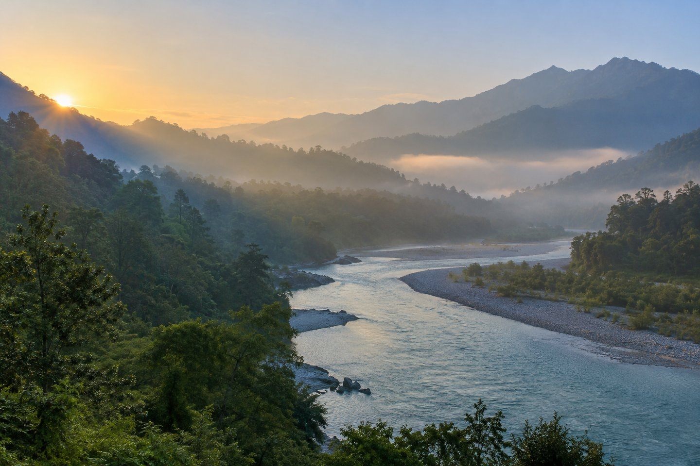 Broad river running through a wooded valley at dawn.